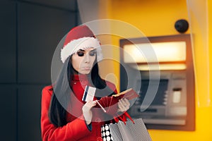 Christmas Woman Checking her Wallet in Front of a Bank ATM