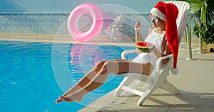 Christmas Woman eating watermelon at the Pool