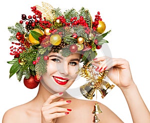 Christmas Woman Gift Bells. Beautiful Girl Fashion Make up and Xmas Party Wreath Hairstyle. Isolated White