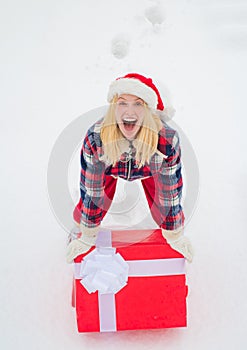 Christmas Woman holding a huge gift box. Woman present red gift box with ribbon bow isolated over white background. Big