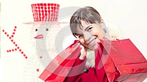 Christmas woman with red bags, smiles, shopping concept