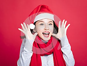 Christmas woman wearing santa hat and surprised