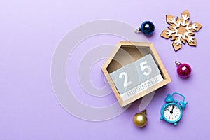 Christmas wood calendar with new year decorations, aganist colored background. Christmas calendar 25 desember