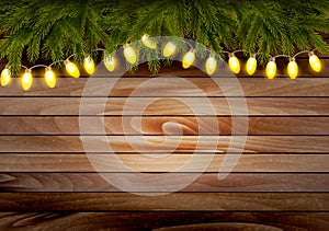 Christmas wooden background with branches and a garland.