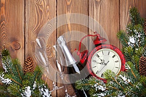 Christmas wooden background with clock, champagne and snow fir t