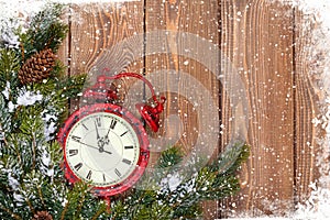 Christmas wooden background with clock and snow fir tree
