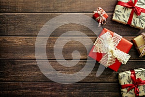 Christmas wooden background with different gift boxes. Flat lay, top view, copy space. Vintage, retro style