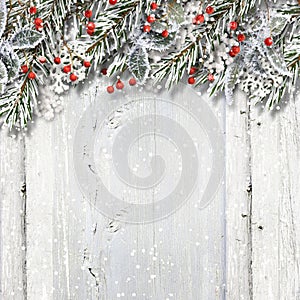 Christmas wooden background with fir branches and holly