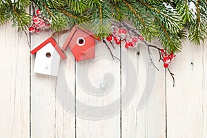 Christmas wooden background with fir tree and birdhouse decor