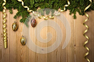 Christmas Wooden Background with fir tree, golden ribbon and dec