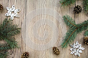 Christmas wooden background with fir tree and handmade snowflakes. Flat lay, top view