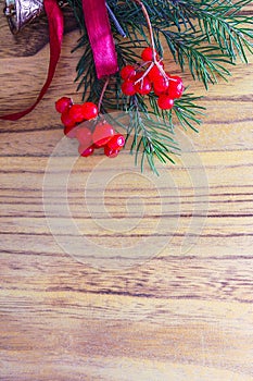 Christmas wooden background with fir tree and red berries