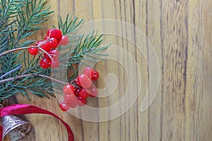 Christmas wooden background with fir tree and red berries