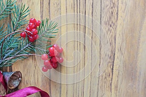 Christmas wooden background with fir tree and red berries