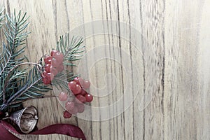 Christmas wooden background with fir tree and red berries