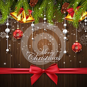 Christmas wooden background with fir tree, red and white balls, gold bells and red bow