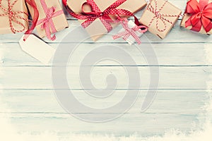 Christmas wooden background with gift boxes and snow