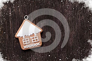 Christmas wooden background with gingerbread cookie house