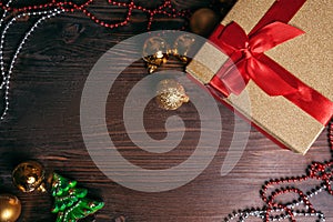 Christmas wooden background, golden balls, gift box, garland