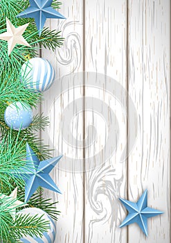Christmas wooden background with green branches and blue ornaments