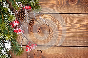 Christmas wooden background with snow fir tree and decor