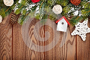 Christmas wooden background with snow fir tree and decor