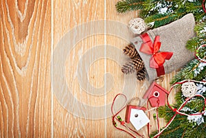 Christmas wooden background with snow fir tree and decor