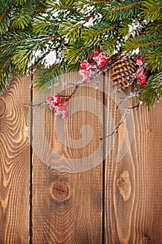 Christmas wooden background with snow fir tree and decor