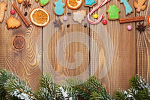 Christmas wooden background with snow fir tree, spices, ginger