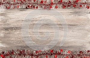 Christmas Wooden gray background with red and silver tinsel