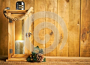 Christmas wooden lantern on background of old wooden boards