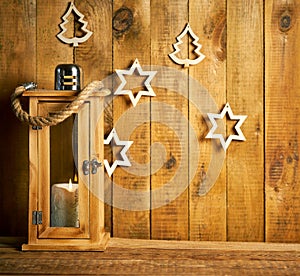 Christmas wooden lantern on background of old wooden boards