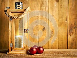 Christmas wooden lantern on background of old wooden boards