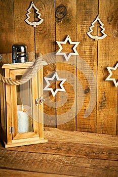 Christmas wooden lantern on background of old wooden boards