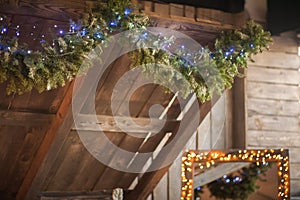 Christmas wooden roof close-up decorated with a garland. Scandinavian style bedroom interior under Christmas. Rustic Textured Wood