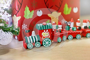 Christmas wooden train toys with snowman and friends and gift box in background