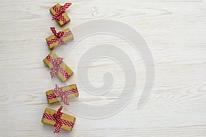 Christmas wrapped gift boxes on white wooden background. template for greeting card. Copy-space. top view