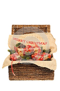 Christmas wrapped gifts with red ribbons on a jute sack with text