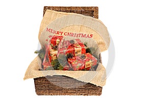 Christmas wrapped gifts with red ribbons on a jute sack with text