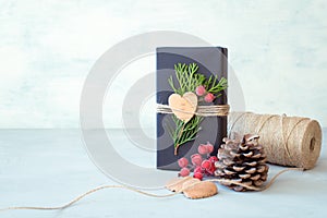 Christmas wrapping. Gift box, present with craft wrapping paper, twine, coniferous branches