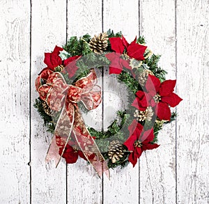 Christmas wreath against white wood