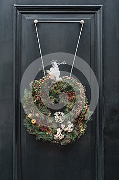 Christmas wreath attached to a green door