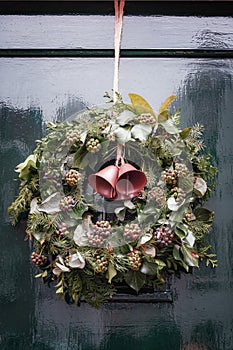 Christmas wreath attached to a green door