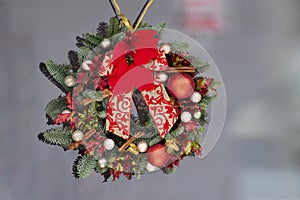 Christmas wreath of branches of a Christmas tree, white,gold and red balls,cinnamon,bow,red berries,poinsettia flower, isolatade.