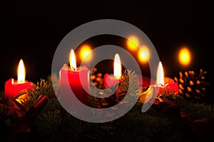 Christmas wreath with burning red candles, advent time