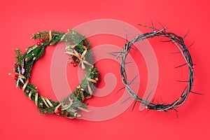 Christmas wreath and crown of thorns on red background. Remember the real Reason of the Season. Christian Christmas and