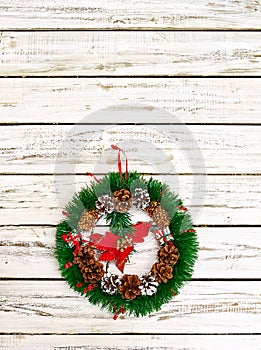 Christmas wreath decoration hangs on front door vertical frame