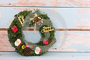 Christmas wreath decoration on retro grunge blue wooden background