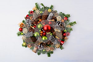 Christmas wreath with fir branches, pine cones and rustic ornaments