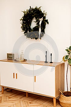 Christmas wreath and furniture in the bright living room